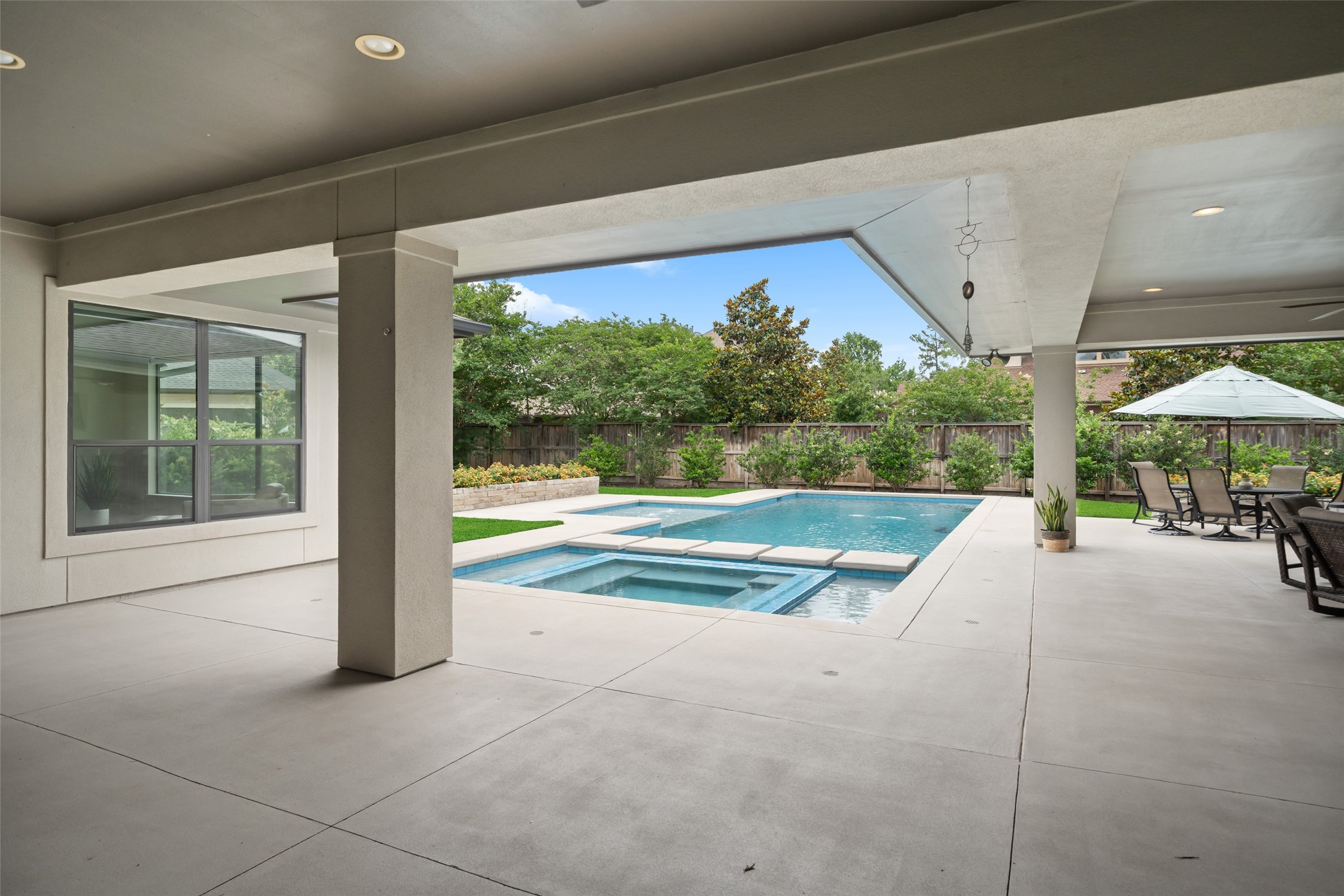 24902 Delaney Knoll Spring, TX 77389 - Photo 40 of 49 a view of swimming pool with table and chairs under an umbrella