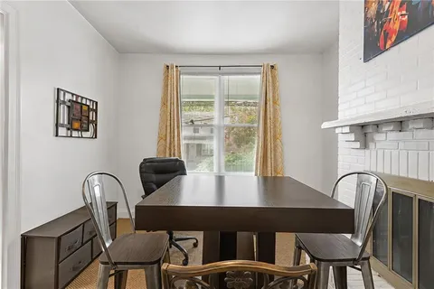 a view of a dining room with furniture and window