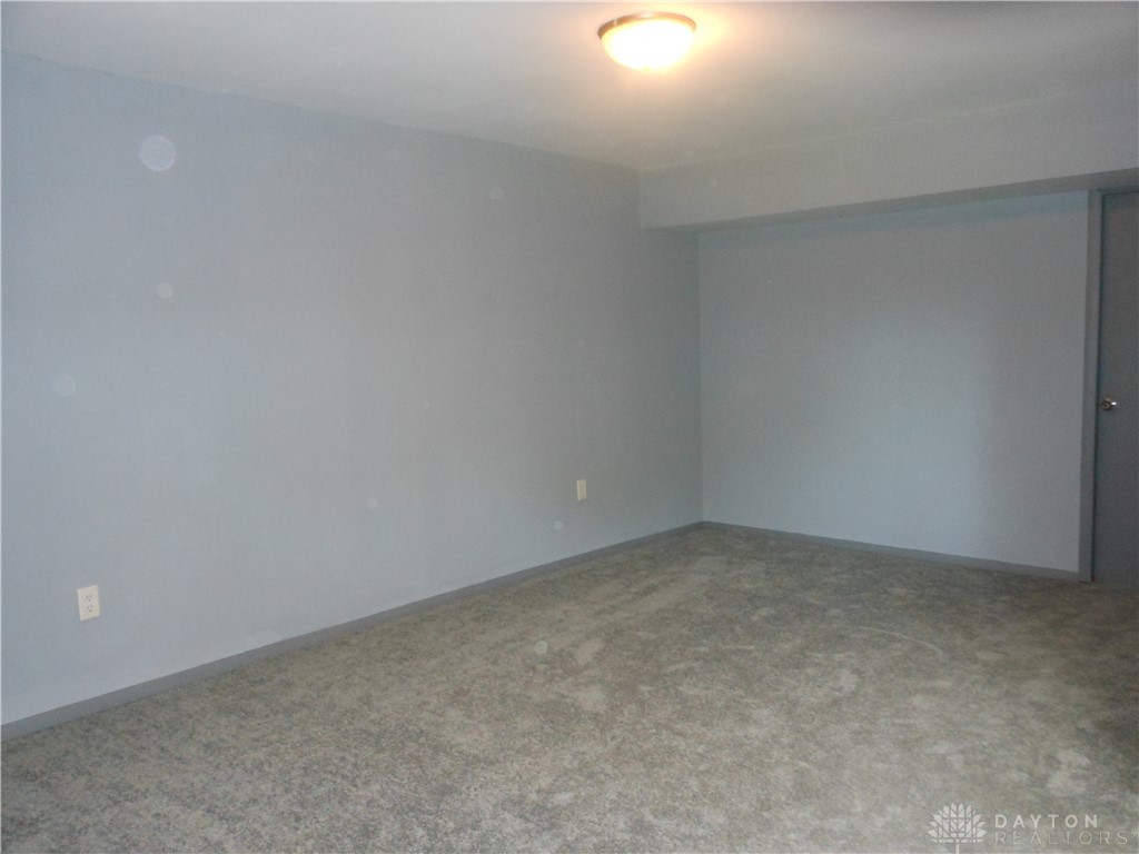 143 West Emerick Road West Milton, OH 45383 - Photo 13 of 37 This versatile room features soft carpeting, offering comfort and flexibility for various uses.