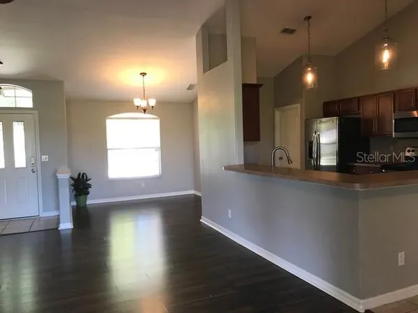 a view of a room with wooden floor and a window