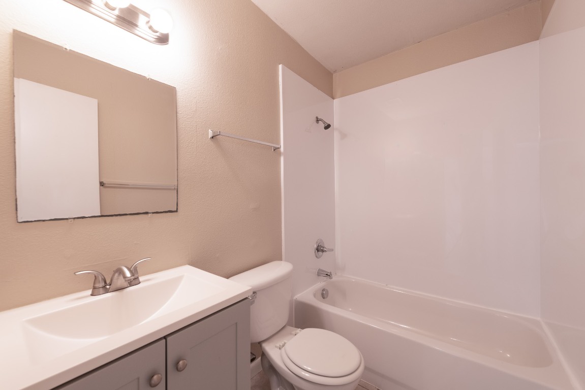 7300 Twin Crest Drive, Unit 202 Austin, TX 78752 - Photo 10 of 12 a bathroom with a sink a toilet and shower