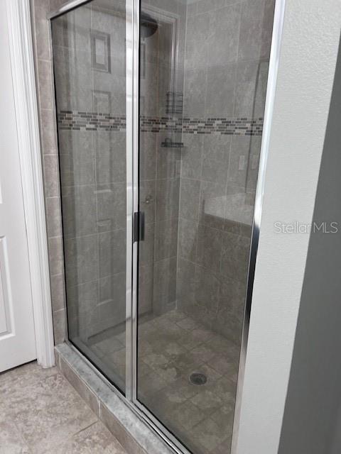 2406 Seven Oaks Drive St. Cloud, FL 34772 - Photo 9 of 11 a bathroom with a glass shower door