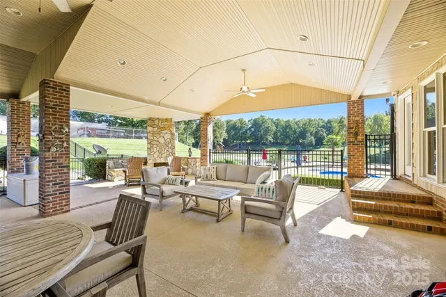 a living room with furniture and a floor to ceiling window