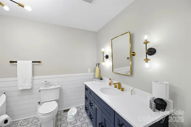 a bathroom with a sink toilet and mirror