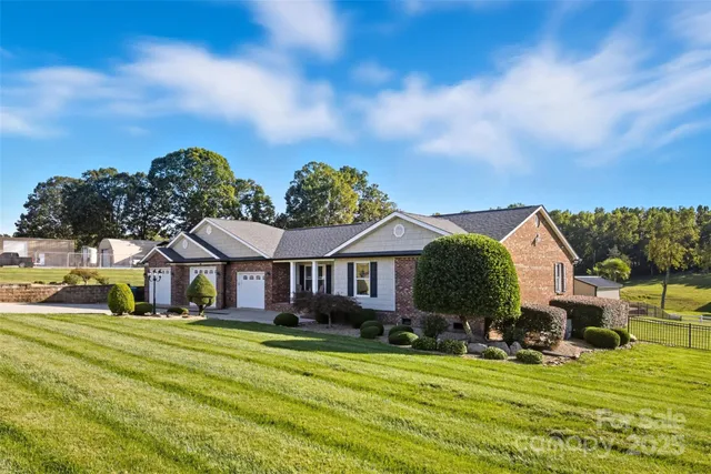 a front view of a house with a big yard