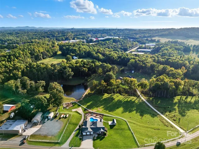 an aerial view of residential houses with outdoor space and river