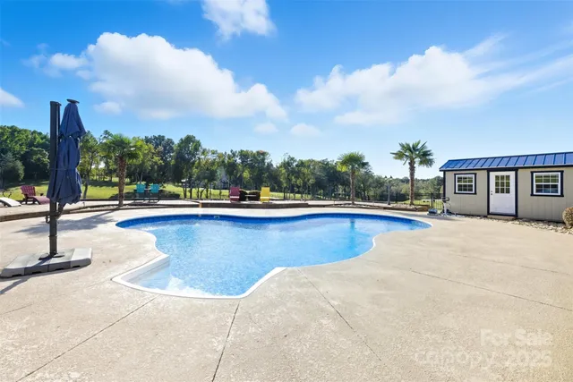 a view of a swimming pool with an outdoor seating