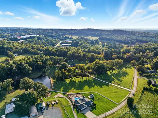 a view of a swimming pool with a patio and a garden