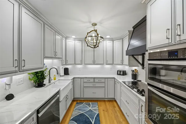 a kitchen with a sink stainless steel appliances and cabinets