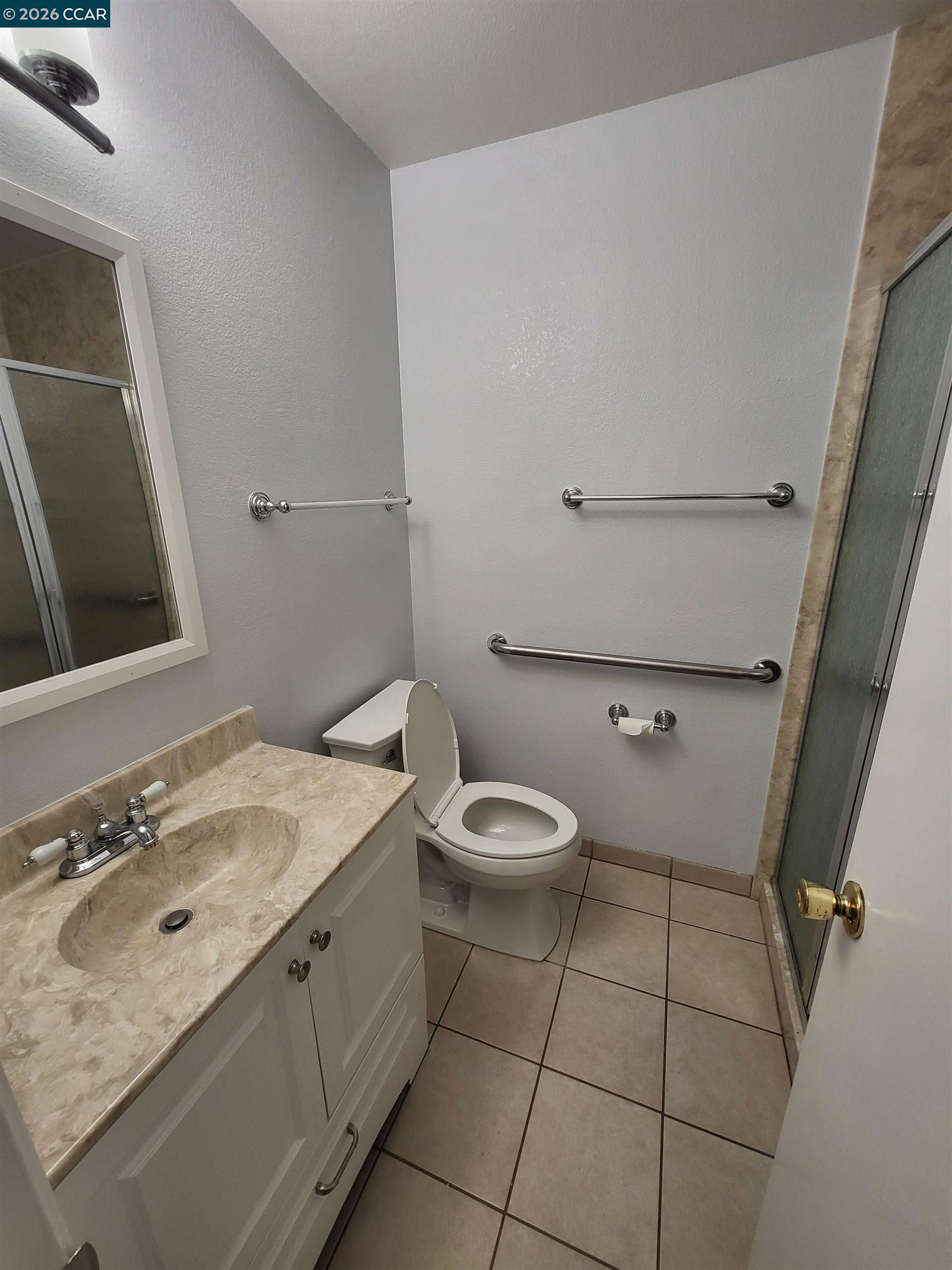 11 Range Court Hercules, CA 94547 - Photo 12 of 18 a bathroom with a granite countertop sink a mirror and toilet