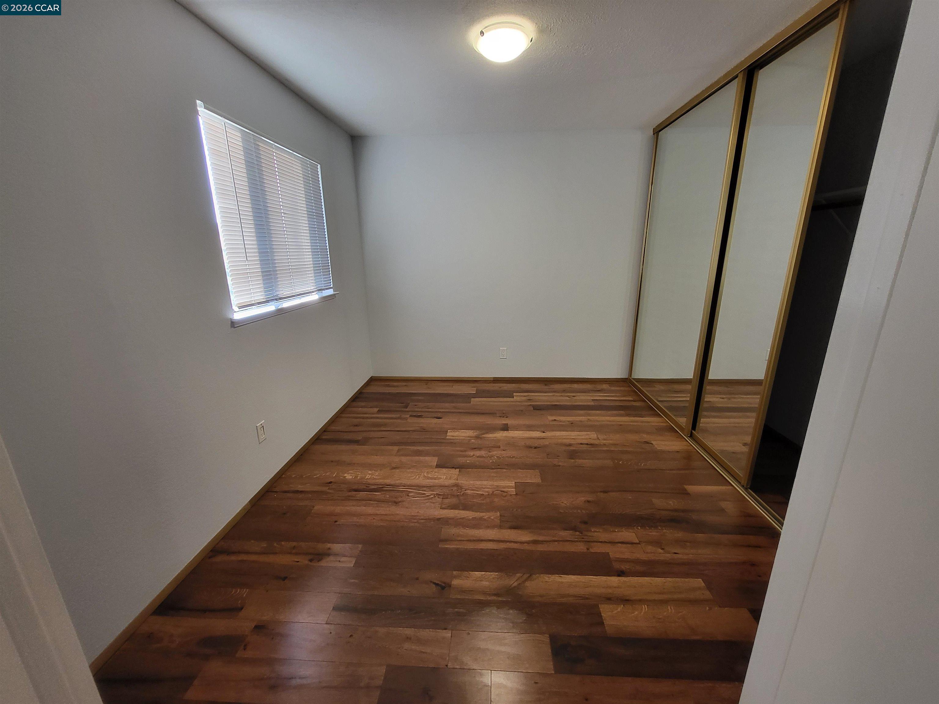 11 Range Court Hercules, CA 94547 - Photo 13 of 18 a view of an empty room with wooden floor and a window