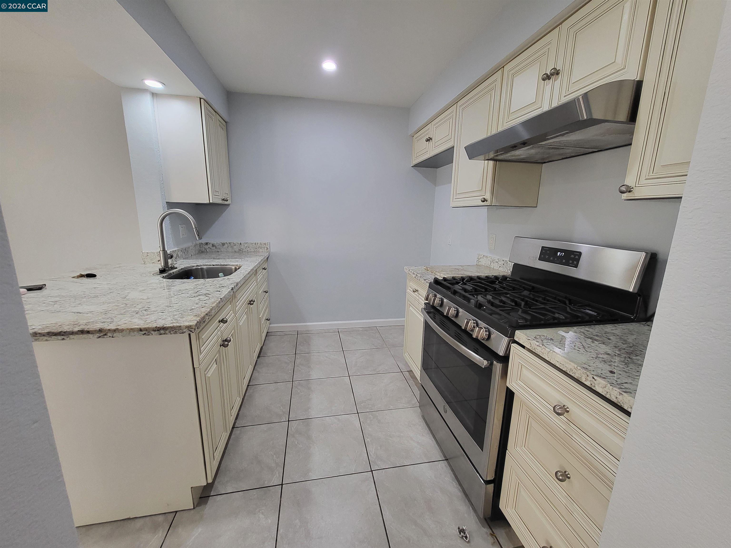 11 Range Court Hercules, CA 94547 - Photo 8 of 18 a kitchen with stainless steel appliances granite countertop a sink stove and cabinets