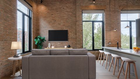 729 North Sangamon Street, Unit 401 Chicago, IL 60642 - Photo 12 of 38 a living room with furniture and a flat screen tv