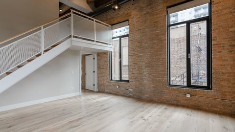 729 North Sangamon Street, Unit 401 Chicago, IL 60642 - Photo 14 of 38 an empty room with wooden floor and windows