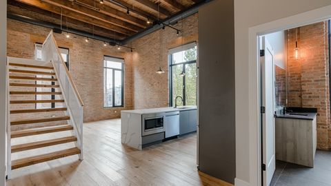 729 North Sangamon Street, Unit 401 Chicago, IL 60642 - Photo 16 of 38 a view of a hallway with wooden floor and staircase