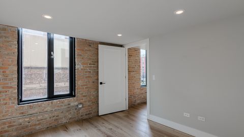 729 North Sangamon Street, Unit 401 Chicago, IL 60642 - Photo 21 of 38 a view of an empty room with a window and wooden floor