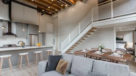a kitchen with stainless steel appliances granite countertop a sink a stove and a refrigerator