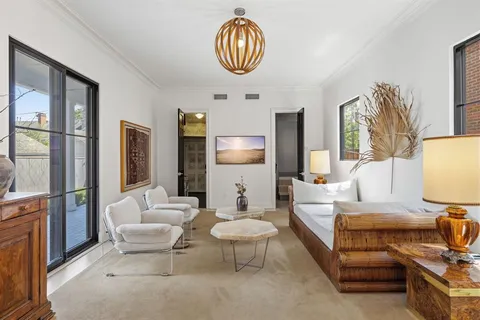 a living room with furniture a lamp and a large window