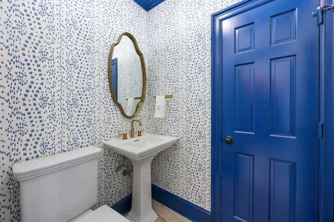 a bathroom with a sink toilet and mirror