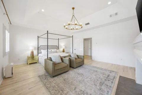 a spacious bedroom with a bed and ceiling fan