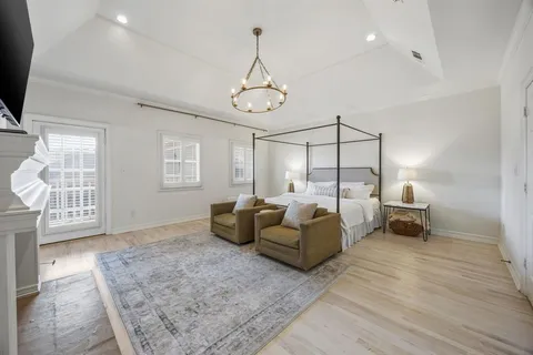 a living room with furniture and a chandelier
