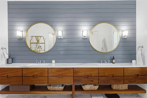 a bathroom with a mirror and vanity