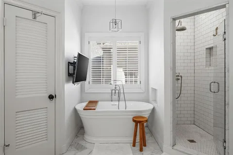a bathroom with a bathtub and a shower