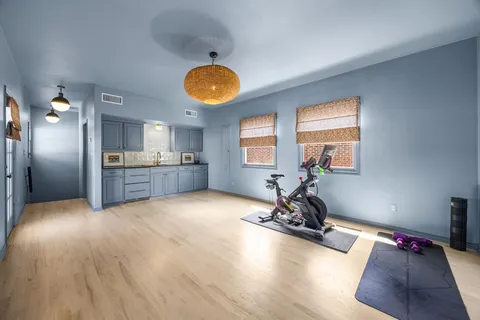a view of a kitchen with a sink oven cabinets and wooden floor
