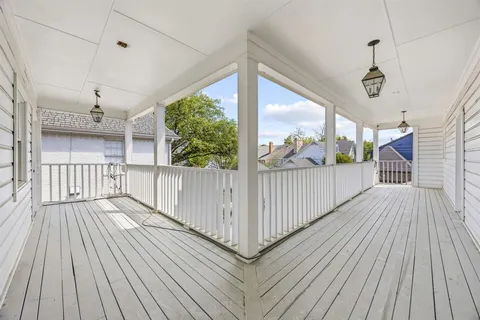 a view of a balcony with wooden floor