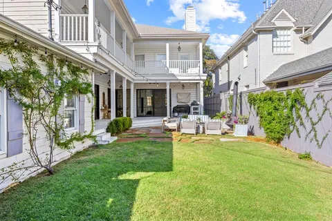 a view of a house with backyard porch and sitting area