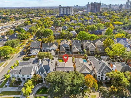 an aerial view of residential houses with outdoor space and parking