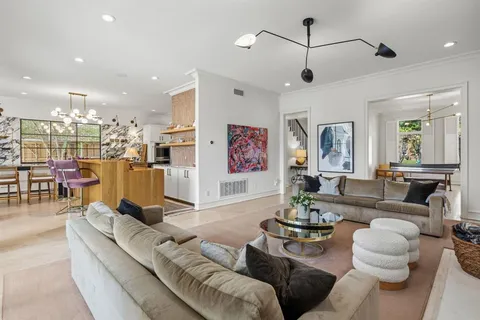 a living room with furniture and kitchen view