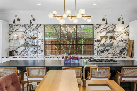 a dining table chairs next to a window