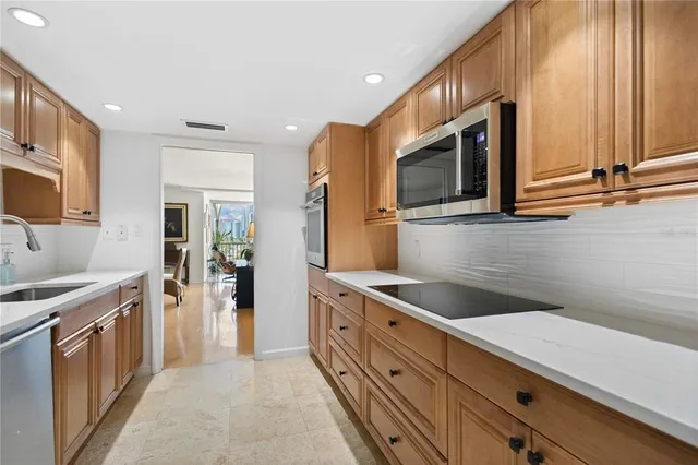 a kitchen with stainless steel appliances granite countertop a sink and a stove