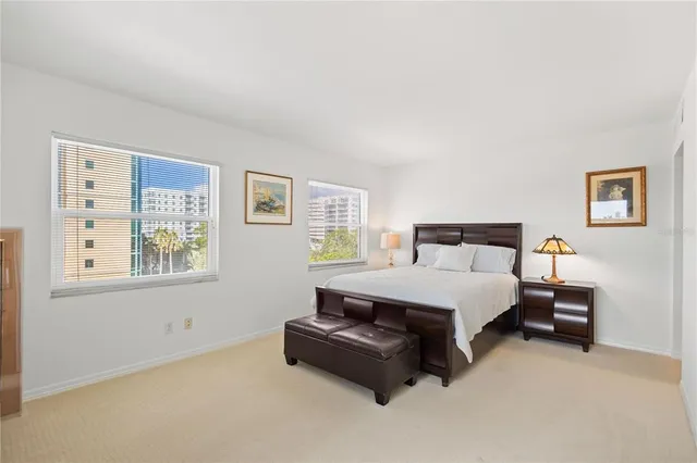 a spacious bedroom with a bed and a window