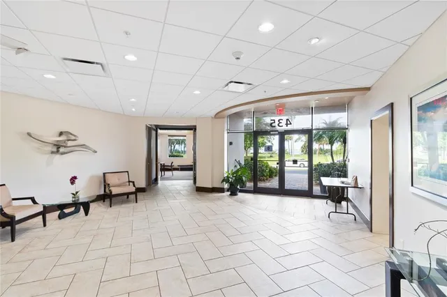 a lobby with furniture and floor to ceiling window