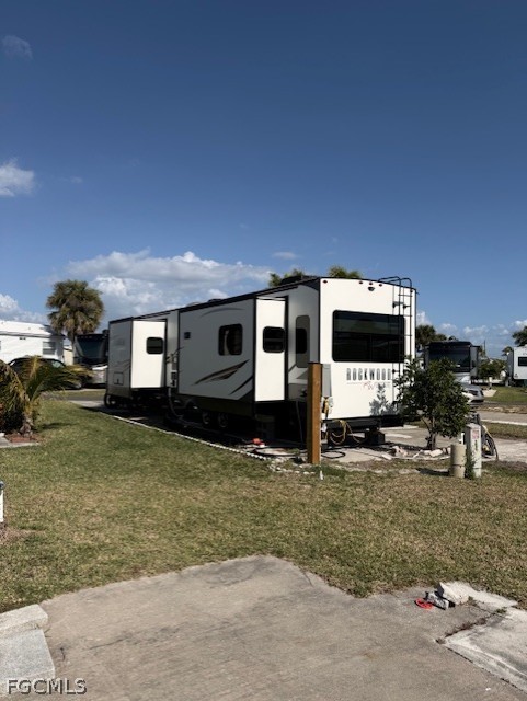 19681-249 Summerlin Road Fort Myers, FL 33908 - Photo 3 of 4 a front view of a house with a yard