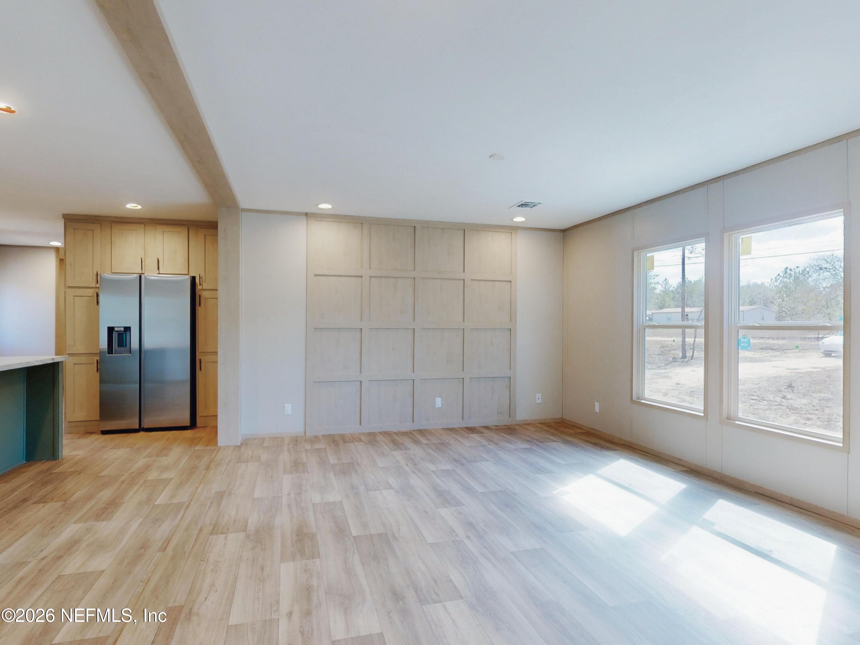 5770 Acadia Street Keystone Heights, FL 32656 - Photo 14 of 64 wooden floor in an empty room with a window