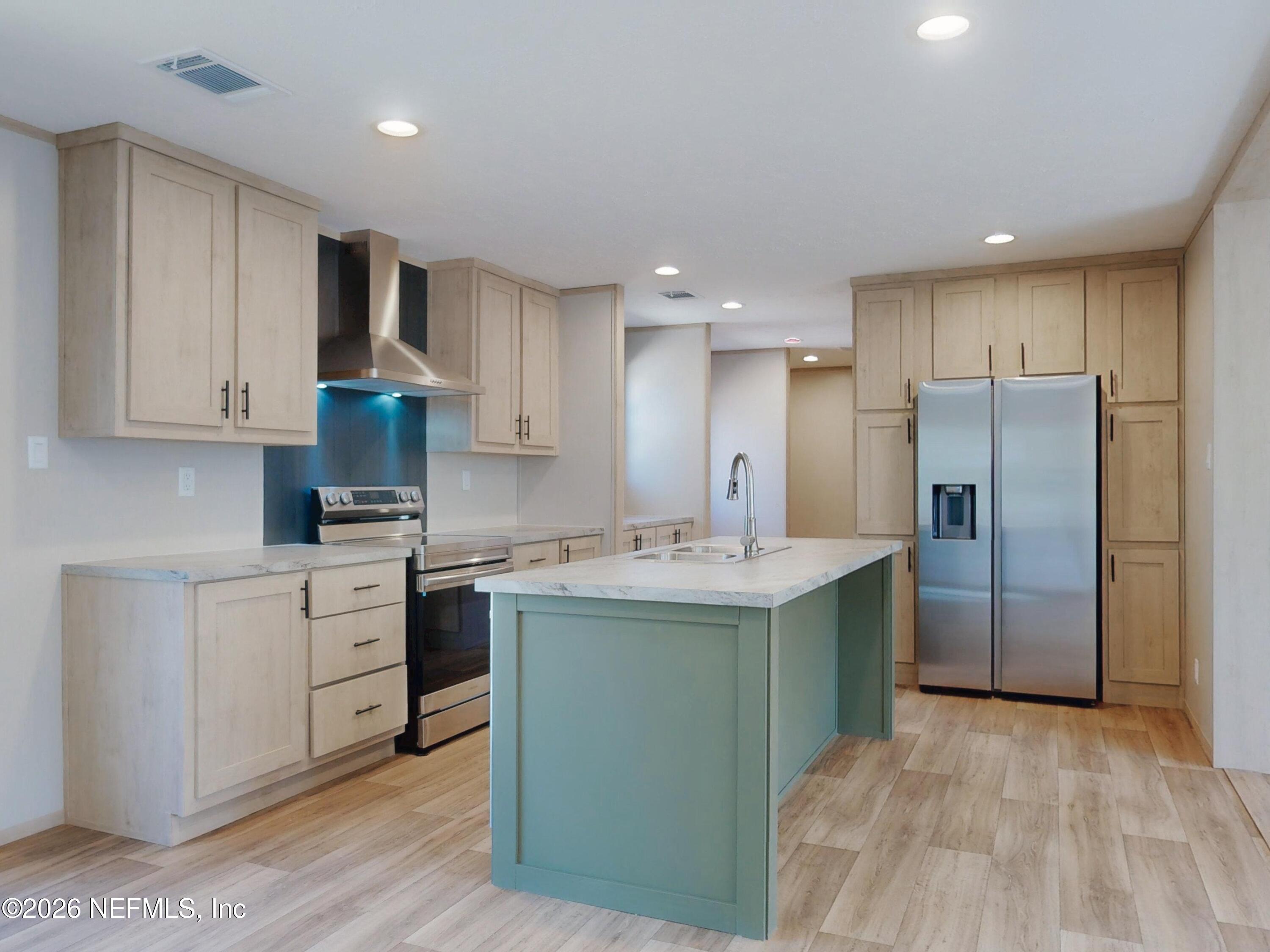 5770 Acadia Street Keystone Heights, FL 32656 - Photo 16 of 64 a kitchen with stainless steel appliances granite countertop a refrigerator and a stove top oven