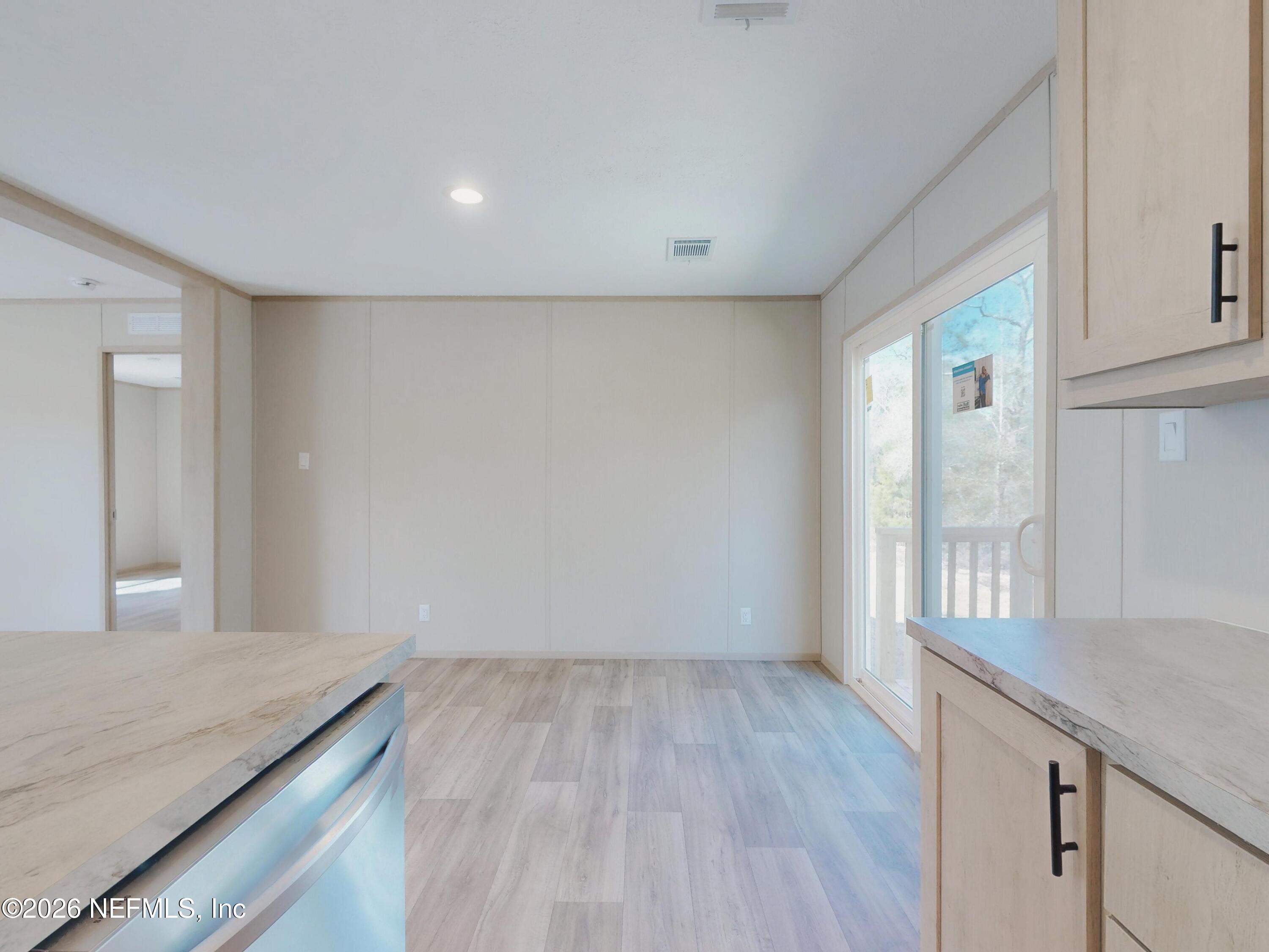 5770 Acadia Street Keystone Heights, FL 32656 - Photo 17 of 64 a view of a kitchen cabinets and wooden floor