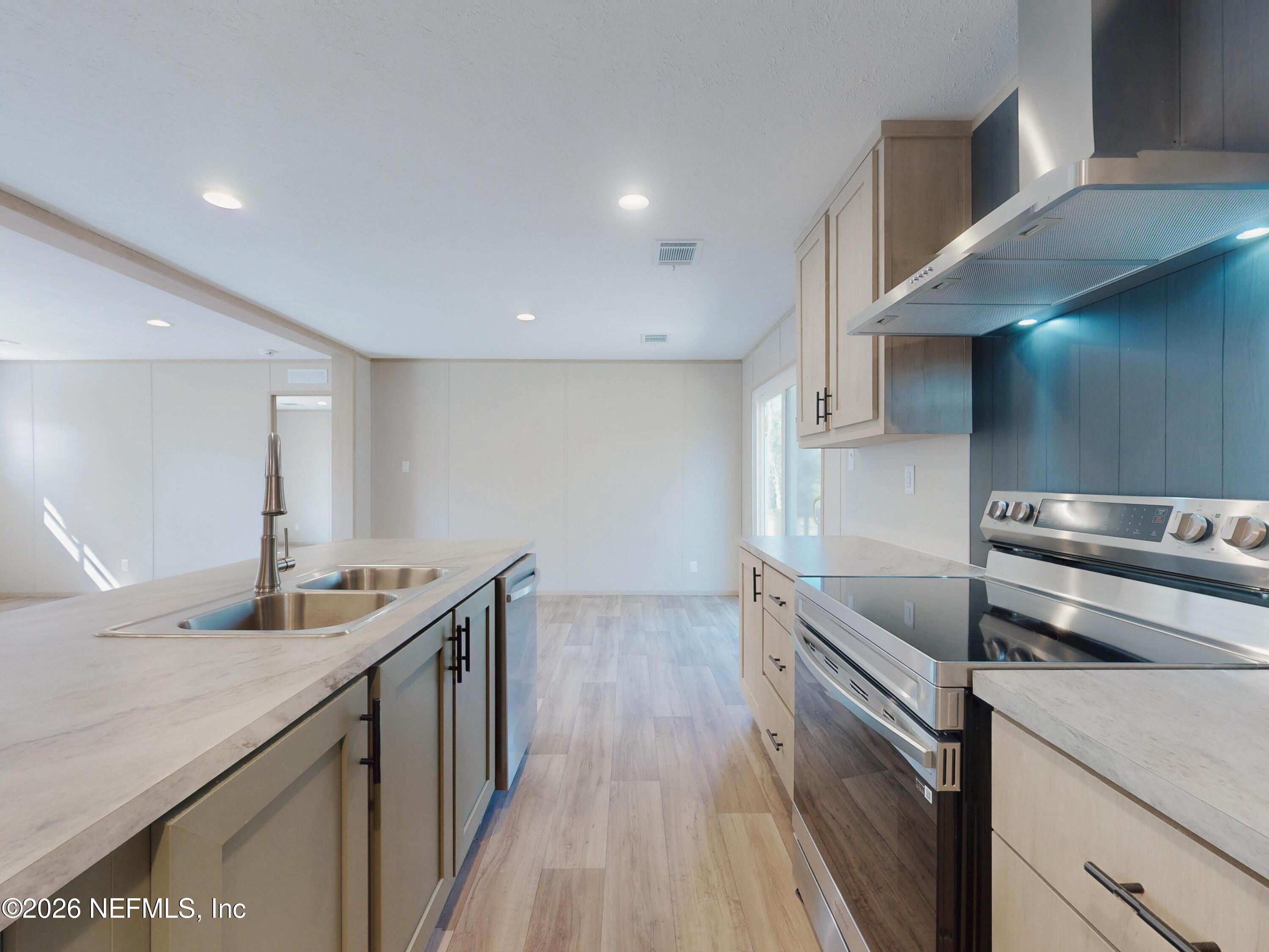 5770 Acadia Street Keystone Heights, FL 32656 - Photo 20 of 64 a kitchen with stainless steel appliances granite countertop a sink and a stove