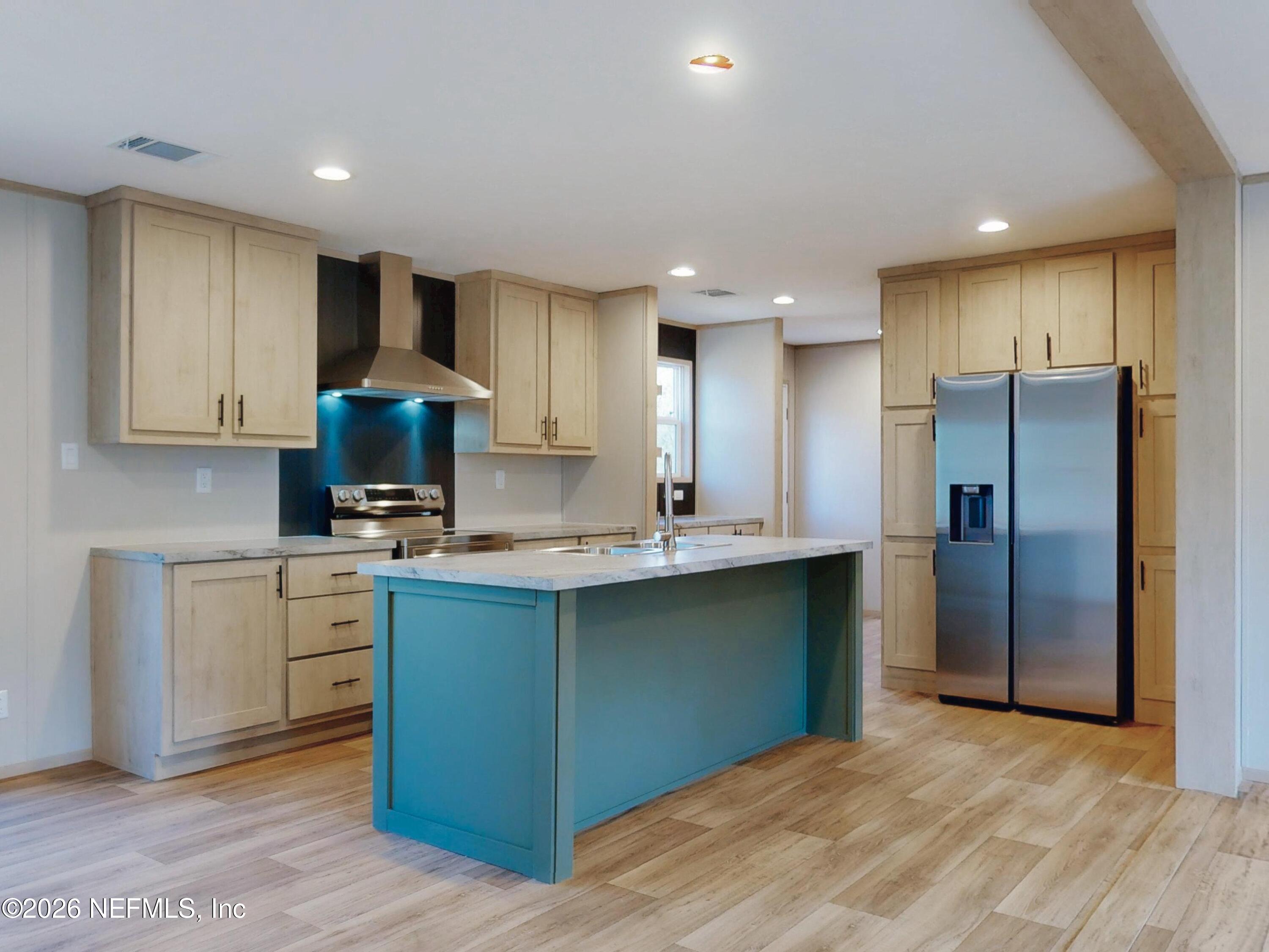 5770 Acadia Street Keystone Heights, FL 32656 - Photo 22 of 64 a kitchen with stainless steel appliances granite countertop a refrigerator sink and cabinets