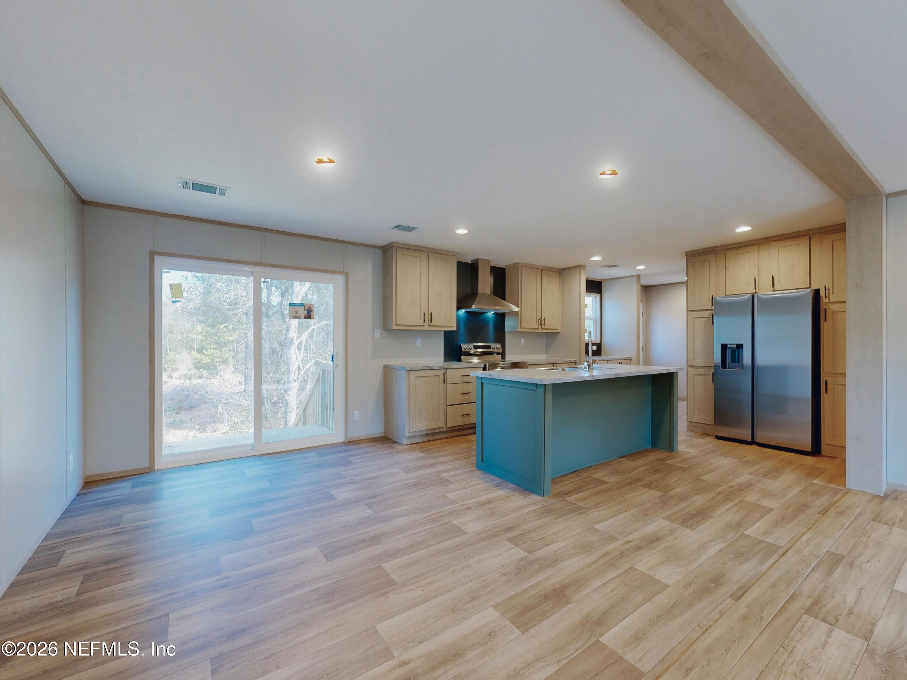 5770 Acadia Street Keystone Heights, FL 32656 - Photo 23 of 64 a kitchen with stainless steel appliances kitchen island a refrigerator and a sink
