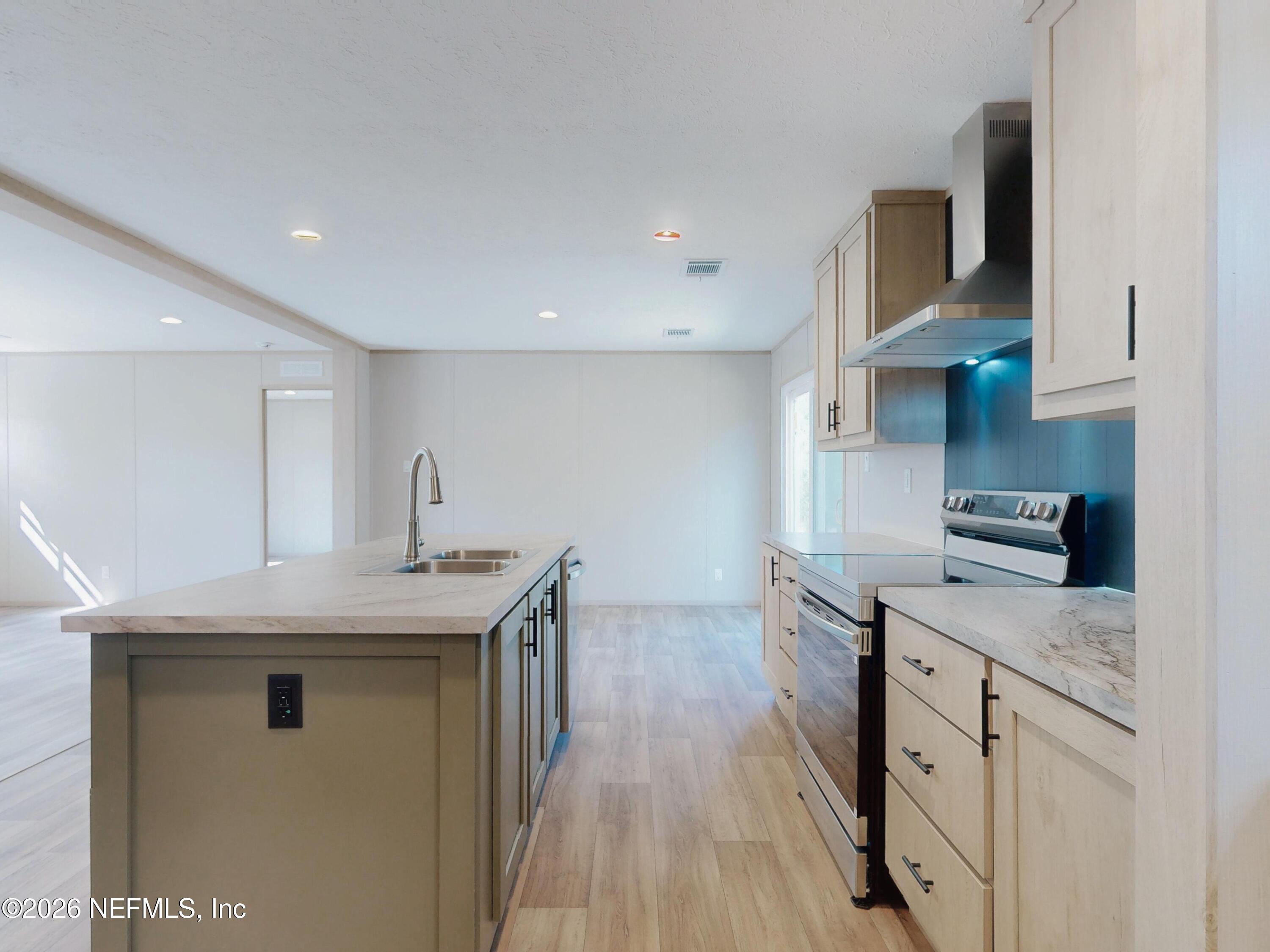 5770 Acadia Street Keystone Heights, FL 32656 - Photo 25 of 64 a kitchen with stainless steel appliances granite countertop a stove and a sink