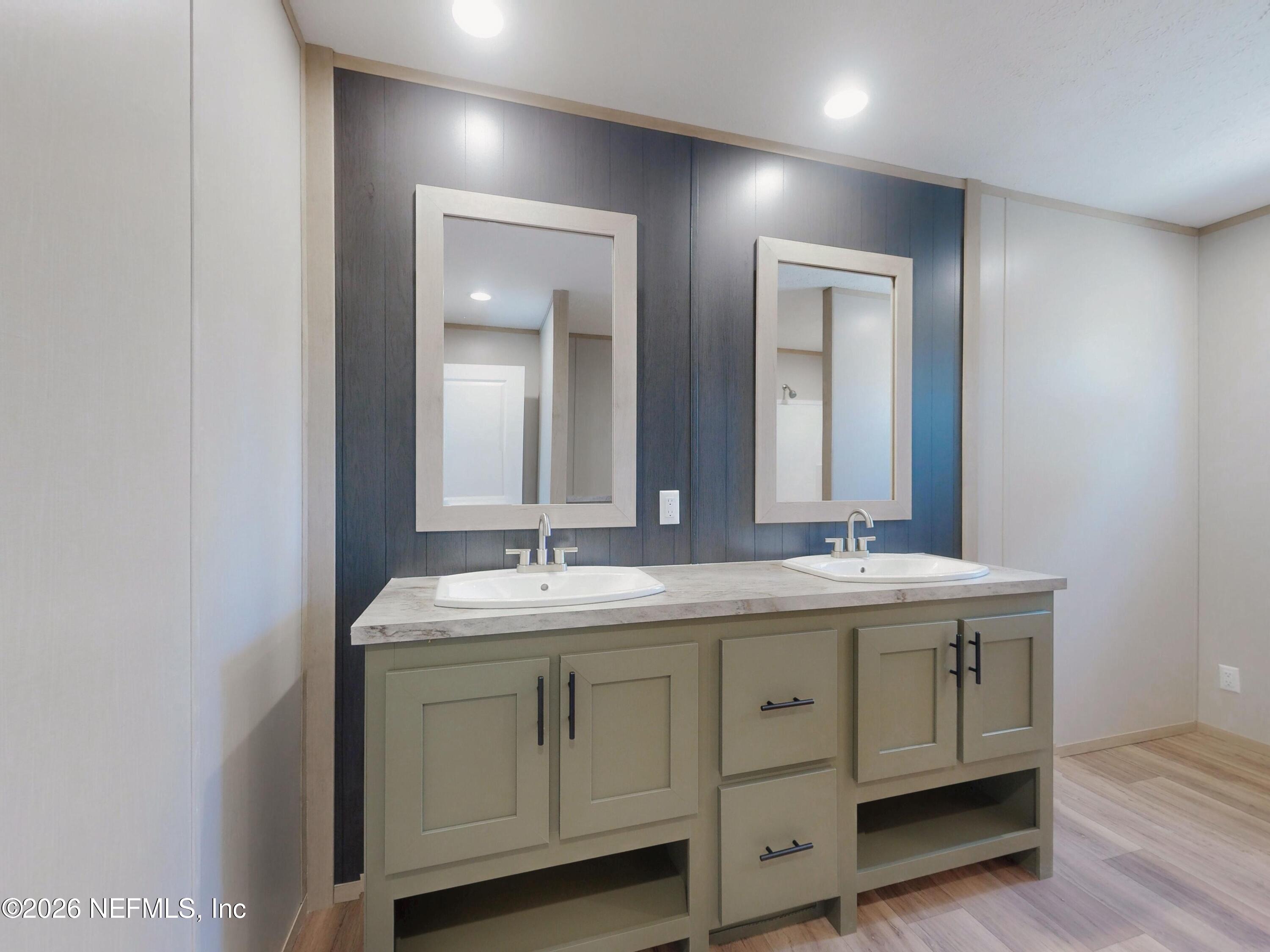 5770 Acadia Street Keystone Heights, FL 32656 - Photo 31 of 64 a bathroom with a double vanity sink and mirror