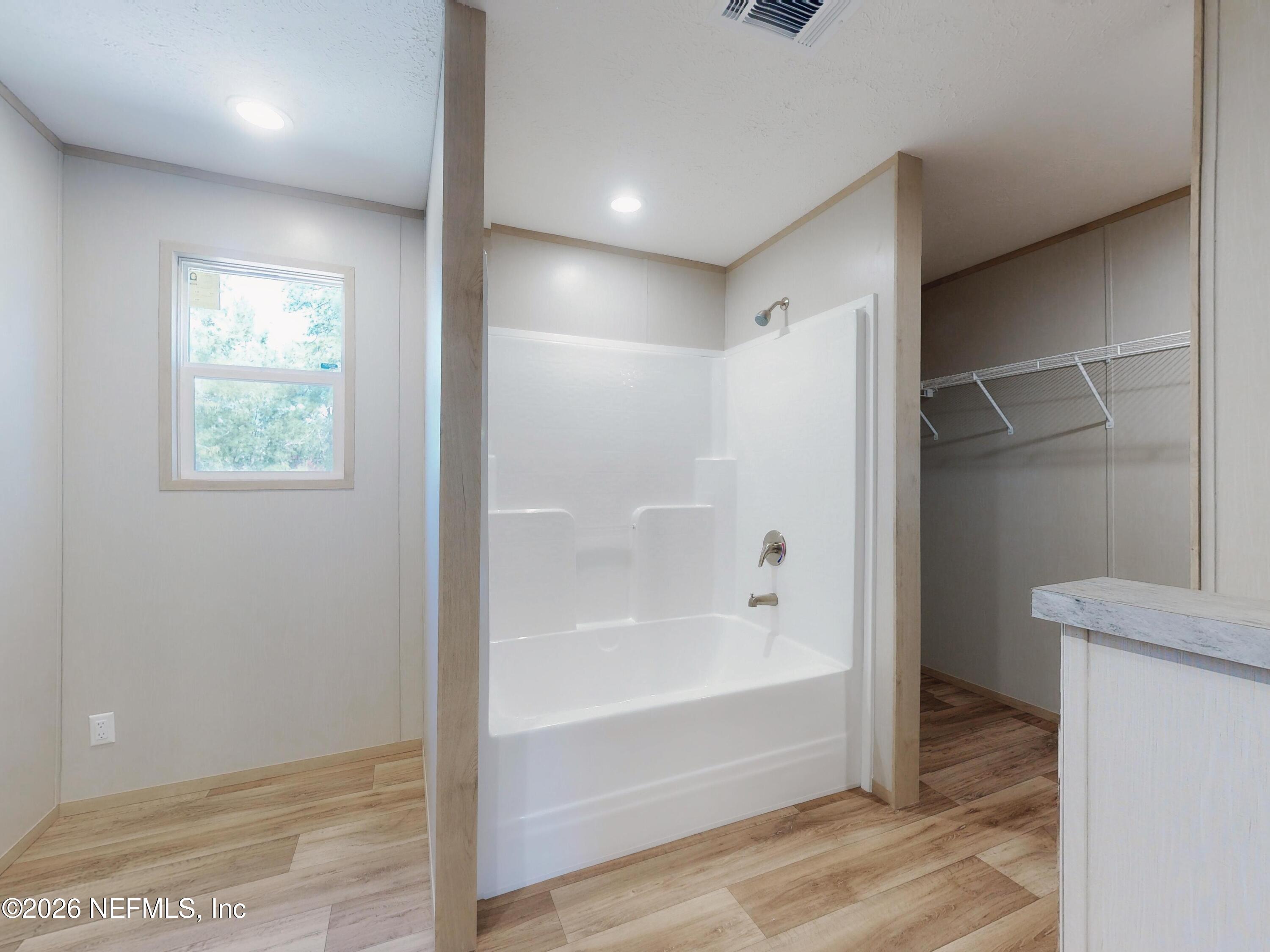 5770 Acadia Street Keystone Heights, FL 32656 - Photo 32 of 64 a bathroom with a bathtub and a shower