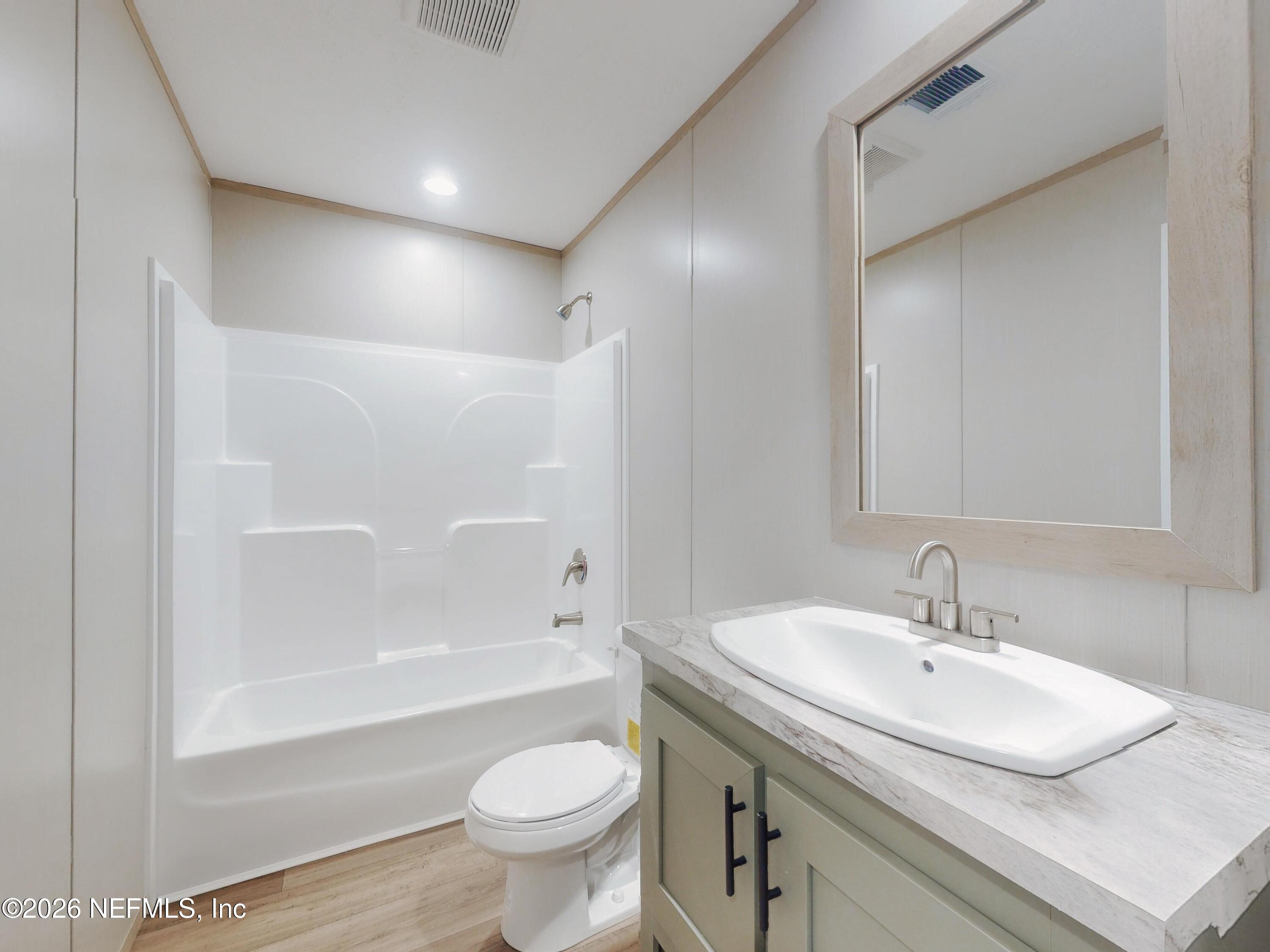 5770 Acadia Street Keystone Heights, FL 32656 - Photo 47 of 64 a bathroom with a sink and a mirror