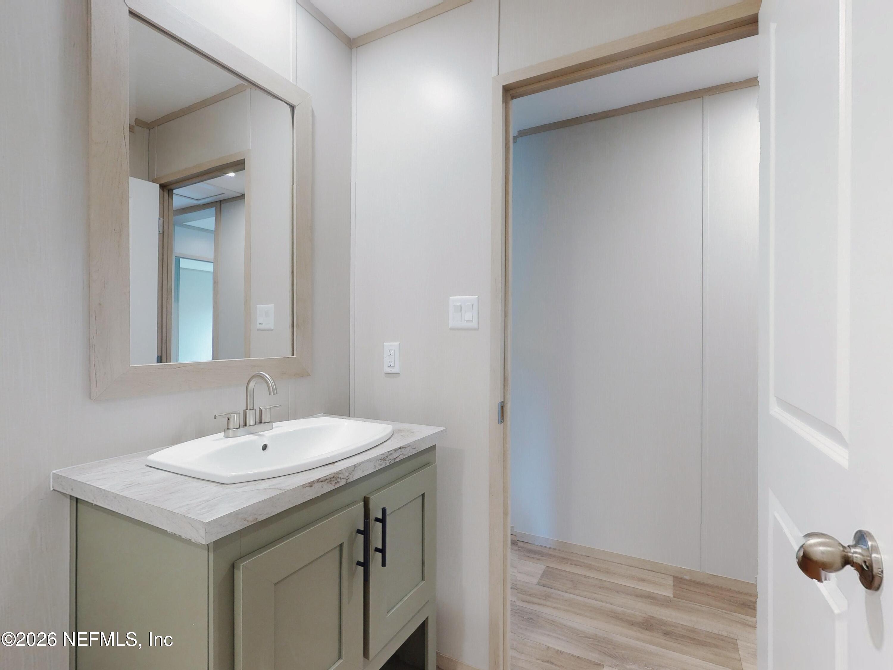 5770 Acadia Street Keystone Heights, FL 32656 - Photo 49 of 64 a bathroom with a sink and a mirror