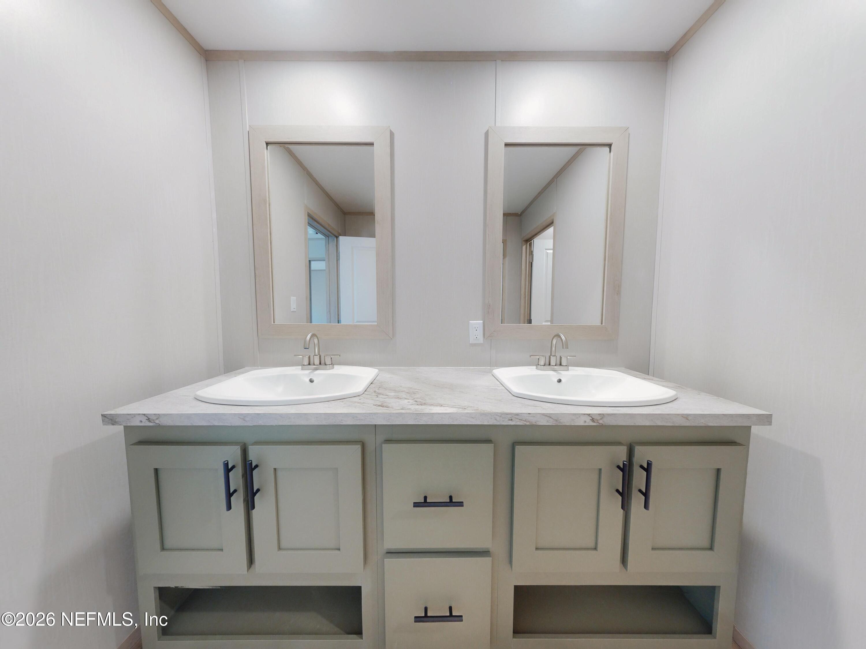 5770 Acadia Street Keystone Heights, FL 32656 - Photo 56 of 64 a bathroom with double sink and a mirror
