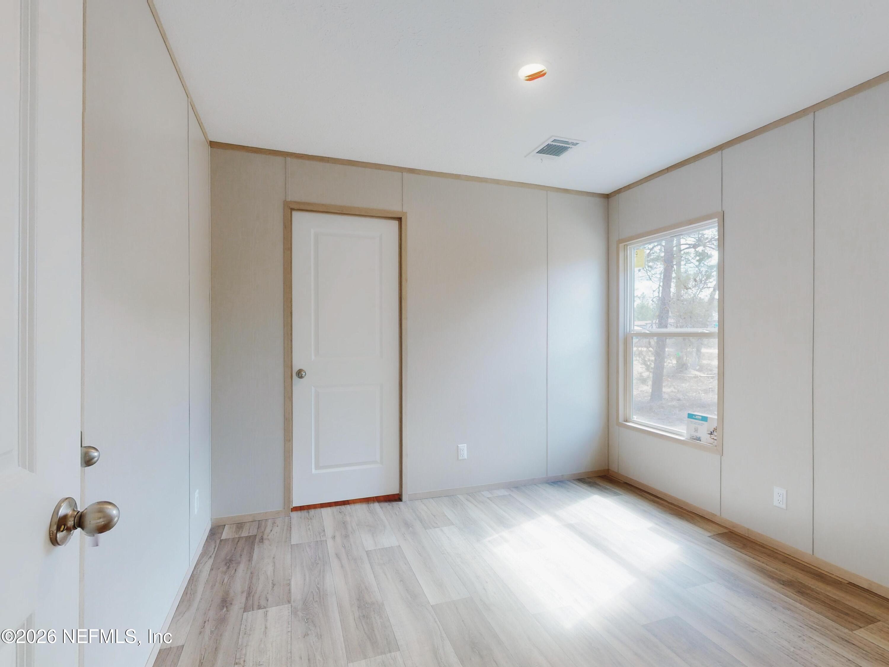 5770 Acadia Street Keystone Heights, FL 32656 - Photo 59 of 64 wooden floor in an empty room with a window